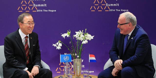 U.N. Secretary General Ban Ki-moon, left, talks with Dutch Foreign Minister Frans Timmermans, at the Nuclear Summit in The Hague, the Netherlands, on Tuesday, March 25, 2014. Nuclear terrorism is officially the main topic for world leaders at a two-day summit in the Netherlands, in practice, the Ukraine crisis overshadows those talks. (AP Photo/Yves Logghe, Pool)