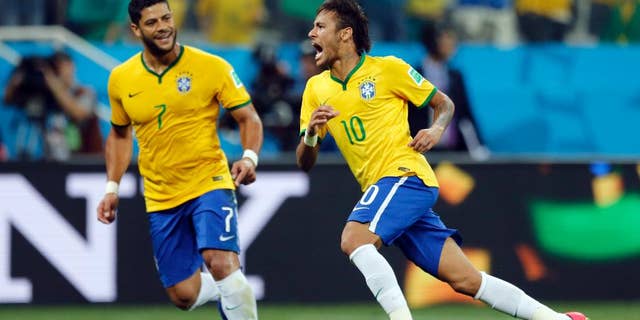 Brazil's Neymar, right, celebrates with teammate Hulk after scoring during the group A World Cup soccer match against Croatia in the opening game of the tournament at Itaquerao Stadium in Sao Paulo, Brazil, Thursday, June 12, 2014. (AP Photo/Frank Augstein)