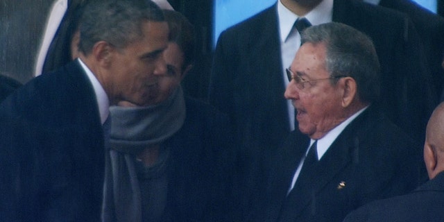 President Obama shakes hands with Cuban President Raul Castro at the FNB Stadium in Soweto, South Africa, during a memorial service for former South African President Nelson Mandela, Tuesday Dec. 10, 2013.