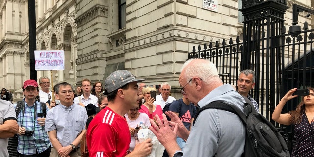 Trump supporters and opponents argue outside Downing Street.