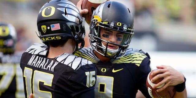 Nov 1, 2014; Eugene, OR, USA; Oregon Ducks quarterback Morgan Mahalak (16) and quarterback Marcus Mariota (8) talk before the game against the Stanford Cardinal at Autzen Stadium. Mandatory Credit: Scott Olmos-USA TODAY Sports