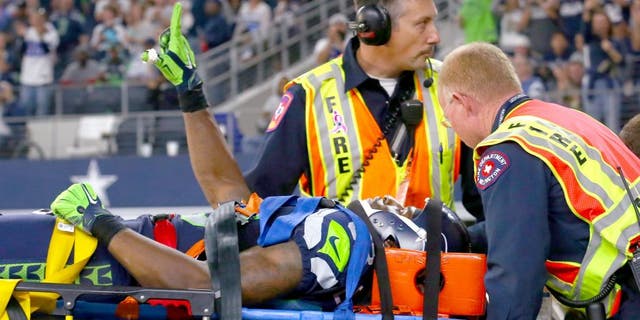 ARLINGTON, TX - NOVEMBER 01: Ricardo Lockette #83 of the Seattle Seahawks waves to fans while being carted off the field in the second quarter at AT&amp;T Stadium on November 1, 2015 in Arlington, Texas. (Photo by Tom Pennington/Getty Images)