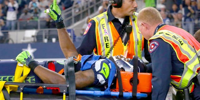 ARLINGTON, TX - NOVEMBER 01: Ricardo Lockette #83 of the Seattle Seahawks waves to fans while being carted off the field in the second quarter at AT&T Stadium on November 1, 2015 in Arlington, Texas. (Photo by Tom Pennington/Getty Images)