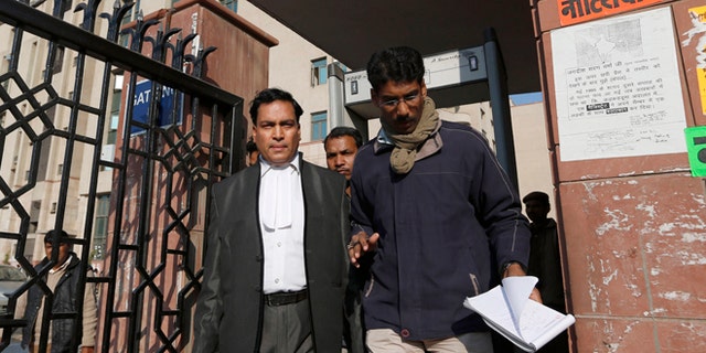 Jan. 10, 2013: Ajay Prakash Singh, left, lawyer for two of the accused, comes out of the Saket district court complex where the accused in a gang rape are to be tried, in New Delhi, India.