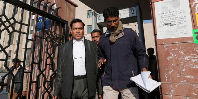 Jan. 10, 2013: Ajay Prakash Singh, left, lawyer for two of the accused, comes out of the Saket district court complex where the accused in a gang rape are to be tried, in New Delhi, India.