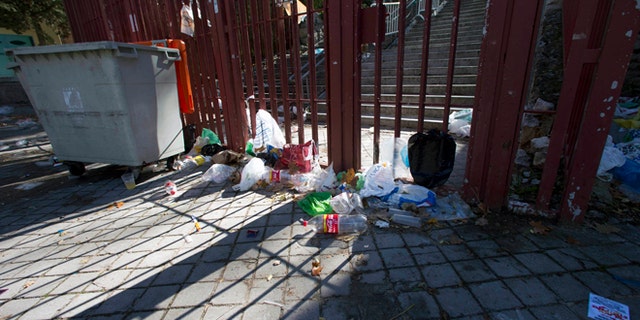 Nov. 1, 2012: Empty bottles and other debris lie outside the closed gates of the Madrid Arena venue in Madrid.