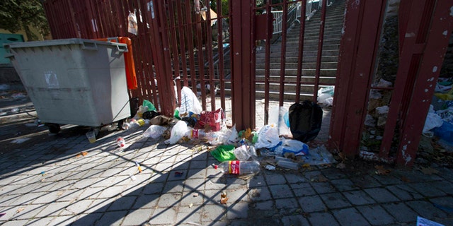 Nov. 1, 2012: Empty bottles and other debris lie outside the closed gates of the Madrid Arena venue in Madrid.