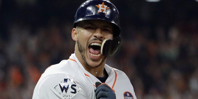 Houston Astros' Carlos Correa celebrates his two-run home run during the seventh inning of Game 5 of baseball's World Series against the Los Angeles Dodgers Sunday, Oct. 29, 2017, in Houston.