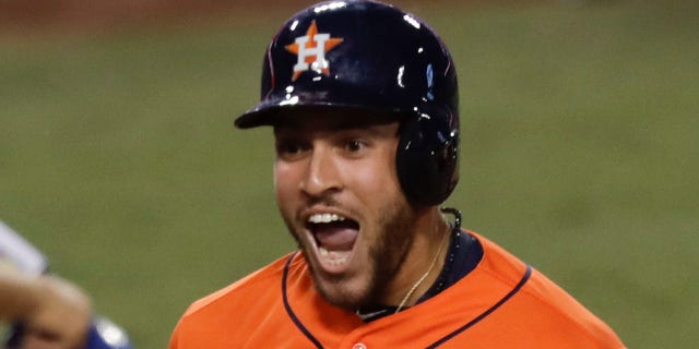 Houston Astros' George Springer (4) celebrates after his two-run home run against the Los Angeles Dodgers during the second inning of Game 7 of baseball's World Series Wednesday, Nov. 1, 2017, in Los Angeles.