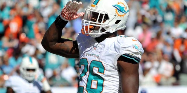 Nov 2, 2014; Miami Gardens, FL, USA; Miami Dolphins running back Lamar Miller (26) celebrates after scoring a touchdown against the San Diego Chargers during the first half at Sun Life Stadium. Mandatory Credit: Steve Mitchell-USA TODAY Sports