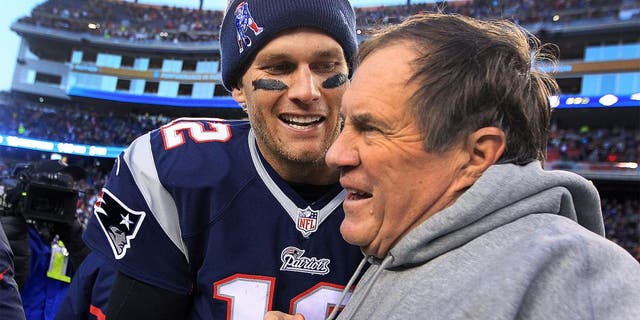 FOXBOROUGH, MA - DECEMBER 14: Patriots quarterback Tom Brady and head coach Bill Belichick share a moment as the final seconds tick off the clock in their victory, which gave them their 6th straight AFC East title. The New England Patriots hosted the Miami Dolphins in a regular season NFL game at Gillette Stadium. (Photo by Jim Davis/The Boston Globe via Getty Images)