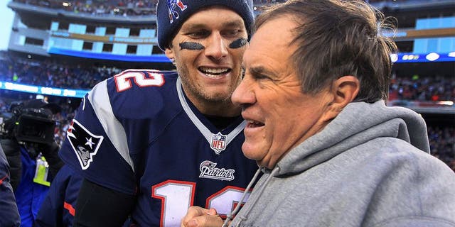 FOXBOROUGH, MA - DECEMBER 14: Patriots quarterback Tom Brady and head coach Bill Belichick share a moment as the final seconds tick off the clock in their victory, which gave them their 6th straight AFC East title. The New England Patriots hosted the Miami Dolphins in a regular season NFL game at Gillette Stadium. (Photo by Jim Davis/The Boston Globe via Getty Images)
