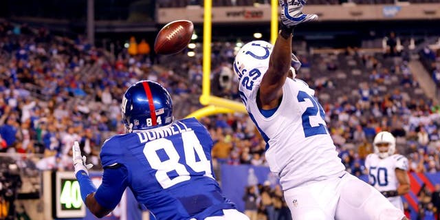 Nov 3, 2014; East Rutherford, NJ, USA; New York Giants tight end Larry Donnell (84) dives for touchdown pass over out stretched hands of Indianapolis Colts strong safety Mike Adams (29) during the second half at MetLife Stadium. Indianapolis Colts defeat the New York Giants 40-24. Mandatory Credit: Jim O'Connor-USA TODAY Sports