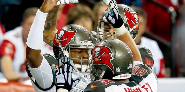 ATLANTA, GA - NOVEMBER 01: Jameis Winston #3 of the Tampa Bay Buccaneers celebrates a touchdown with Joe Hawley #68 of the Tampa Bay Buccaneers during the second half against the Atlanta Falcons at the Georgia Dome on November 1, 2015 in Atlanta, Georgia. (Photo by Kevin C. Cox/Getty Images)