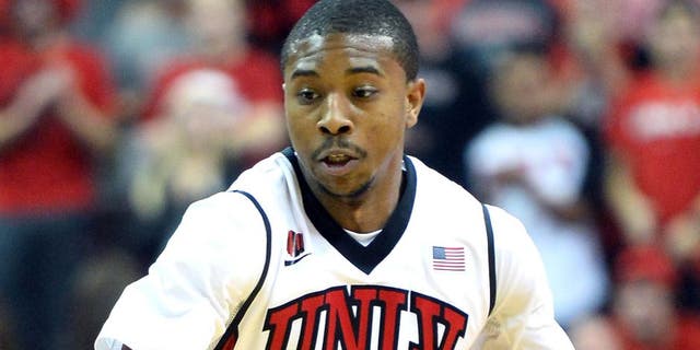 LAS VEGAS, NV - NOVEMBER 26: Daquan Cook #10 of the UNLV Rebels brings the ball up the court against the Illinois Fighting Illini during their game at the Thomas & Mack Center on November 26, 2013 in Las Vegas, Nevada. Illinois won 61-59. (Photo by Ethan Miller/Getty Images)