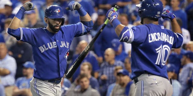 KANSAS CITY, MO - OCTOBER 23: Toronto Blue Jays right fielder Jose Bautista (19) and Toronto Blue Jays designated hitter Edwin Encarnacion (10) celebrate Bautista's 2 run home run in the top of the 8th inning to tie the game. Toronto Blue Jays Vs Kansas City Royals in Game 6 of the ALCS at Kauffman Field. Jays lose 4-3 and lose the series 4-2. Kansas City goes on to the World Series against the New York Mets. Toronto Star/Rick Madonik (Rick Madonik/Toronto Star via Getty Images)