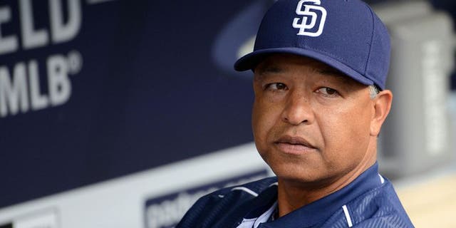 Jun 15, 2015; San Diego, CA, USA; San Diego Padres interim manager Dave Roberts (8) looks on from the dugout prior to the game against the Oakland Athletics at Petco Park. Mandatory Credit: Jake Roth-USA TODAY Sports