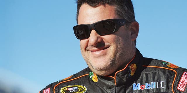 MARTINSVILLE, VA - OCTOBER 30: Tony Stewart, driver of the #14 Bass Pro Shops/Mobil 1 Chevrolet, stands on the grid during qualifying for the NASCAR Sprint Cup Series Goody's Headache Relief Shot 500 at Martinsville Speedway on October 30, 2015 in Martinsville, Virginia. (Photo by Rainier Ehrhardt/Getty Images)