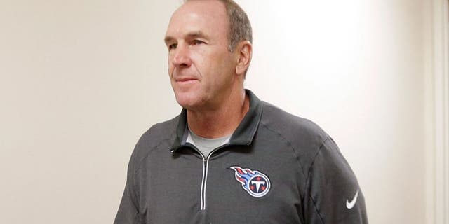 The Tennessee Titans assistant head coach/tight ends coach Mike Mularkey, left, walks to a news conference after it was announced that he has been named the interim head coach after the team fired head coach Ken Whisenhunt Tuesday, Nov. 3, 2015, in Nashville, Tenn. (AP Photo/Mark Humphrey)