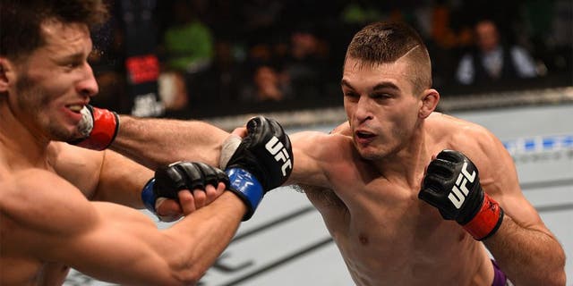 BOSTON, MA - JANUARY 18: (R-L) Johnny Case punches Frankie Perez in their lightweight fight during the UFC Fight Night event at the TD Garden on January 18, 2015 in Boston, Massachusetts. (Photo by Jeff Bottari/Zuffa LLC/Zuffa LLC via Getty Images)
