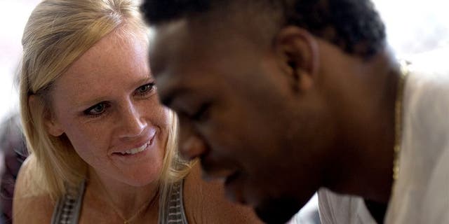 ALBUQUERQUE, NM - OCTOBER 31: (L-R) Holly Holm and Jon Jones sign autographs for fans during the Jackson Wink MMA Academy Grand Opening at Jackson's Mixed Martial Arts & Fitness on October 31, 2015 in Albuquerque, New Mexico. (Photo by Brandon Magnus/Zuffa LLC/Zuffa LLC via Getty Images)