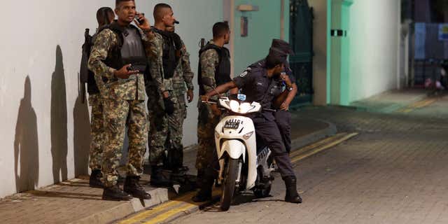Nov. 2, 2015: Maldivian security officers stand guard near the president's official residence where the military found and deactivated an explosive device in Male, Maldives.