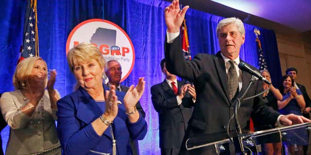 Nov. 3, 2015: Republican Gov. Phil Bryant, right, and wife Deborah acknowledge friends and supporters during an election day party in Jackson, Miss.