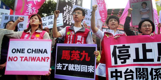 Nov. 4, 2015: Opposition protesters shout slogans with placards opposing the planned meeting of Taiwan's President Ma Ying-jeou with his China counterpart Xi Jinping in Taipei, Taiwan.