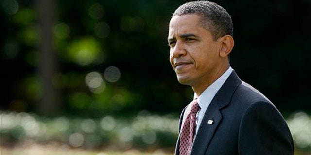 President Obama walks on the South Lawn of the White House, Nov. 4, 2009, as he left for a trip to Madison, Wis. (AP)