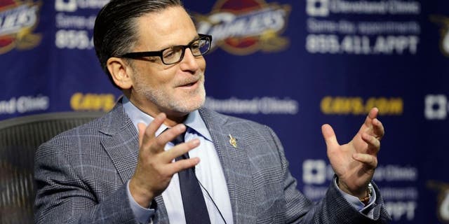 Cleveland Cavaliers owner Dan Gilbert answers questions during a news conference on the day before the NBA basketball team's opening game Wednesday, Oct. 29, 2014, in Cleveland. (AP Photo/Mark Duncan)