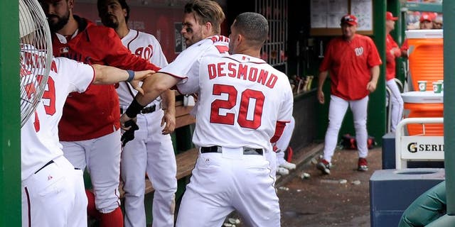 WASHINGTON, DC - SEPTEMBER 27: Bryce Harper #34 of the Washington Nationals is pulled away by Ian Desmond #20 after an altercation with Jonathan Papelbon #58 (not pictured) in the eighth inning against the Philadelphia Phillies at Nationals Park on September 27, 2015 in Washington, DC. (Photo by Greg Fiume/Getty Images)