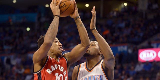 Nov 4, 2015; Oklahoma City, OK, USA; Toronto Raptors guard DeMar DeRozan (10) attempts a shot against Oklahoma City Thunder forward Kevin Durant (35) during the first quarter at Chesapeake Energy Arena. Mandatory Credit: Mark D. Smith-USA TODAY Sports