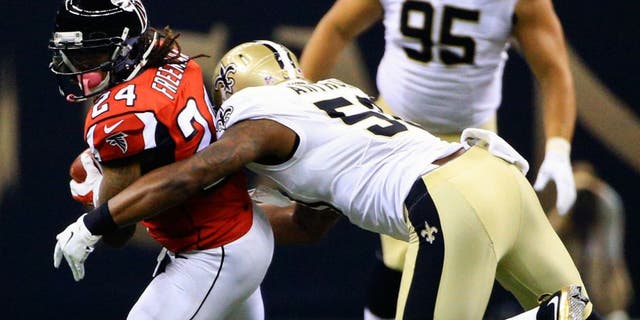 Oct 15, 2015; New Orleans, LA, USA; Atlanta Falcons running back Devonta Freeman (24) is tackled by New Orleans Saints middle linebacker Stephone Anthony (50) during the first quarter of a game at the Mercedes-Benz Superdome. Mandatory Credit: Derick E. Hingle-USA TODAY Sports
