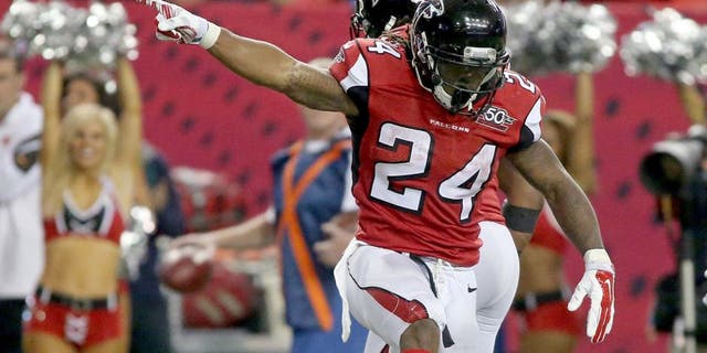 Nov 1, 2015; Atlanta, GA, USA; Atlanta Falcons running back Devonta Freeman (24) celebrates his first down run as Tampa Bay Buccaneers strong safety Chris Conte (23) is shown on the play in the fourth quarter of their game at the Georgia Dome. The Buccaneers won 23-20 in overtime. Mandatory Credit: Jason Getz-USA TODAY Sports