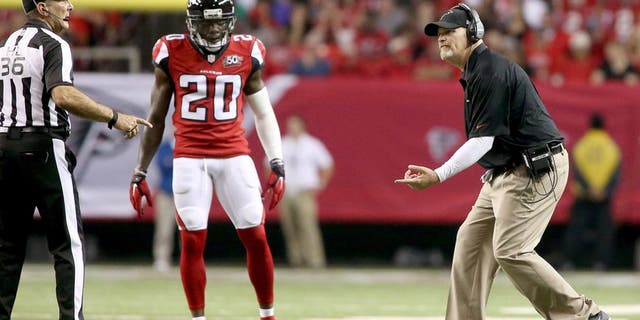 Nov 1, 2015; Atlanta, GA, USA; Atlanta Falcons head coach Dan Quinn argues a call with official Tony Veteri (36) as defensive back Phillip Adams (20) watches in the fourth quarter of their game against the Tampa Bay Buccaneers at the Georgia Dome. The Buccaneers won 23-20 in overtime. Mandatory Credit: Jason Getz-USA TODAY Sports