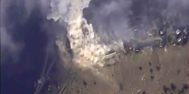 Nov. 2, 2015: This photo made from the footage taken from Russian Defense Ministry official web site shows a target hit during s Russian air raid in Syria.
