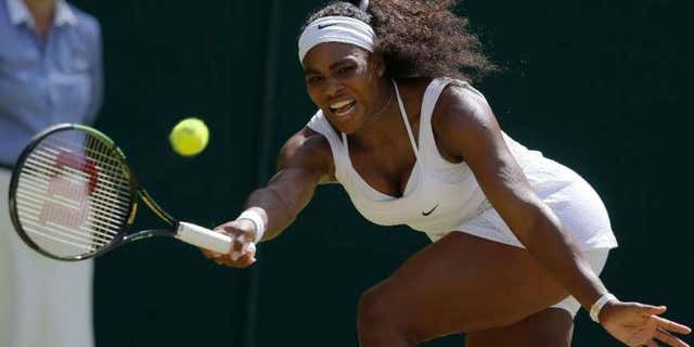 July 11, 2015: Serena Williams of the United States returns a shot to Garbine Muguruza of Spain, during the women's singles final at the All England Lawn Tennis Championships in Wimbledon, London.