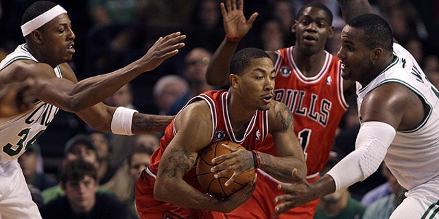 Nov. 5: Chicago Bulls guard Derrick Rose, center, is surrounded by Boston Celtics forwards Paul Pierce, left, and Glen Davis, right, during the first half of their NBA basketball game in Boston.