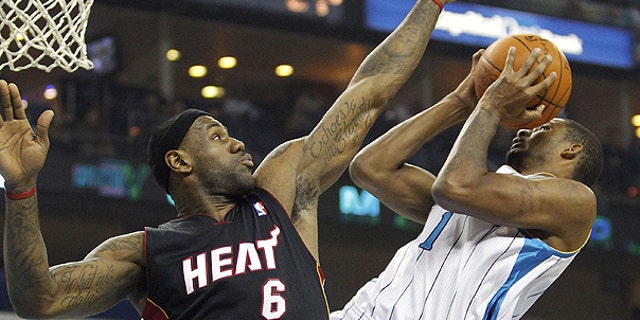 NOv. 5: Miami Heat forward LeBron James (6) contests the shot of New Orleans Hornets small forward Trevor Ariza (1) in the first half of an NBA basketball game in New Orleans.