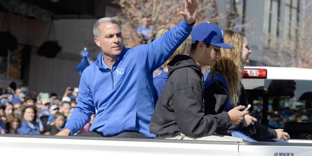 Nov 3, 2015; Kansas City, MO, USA; Kansas City Royals general manager Dayton Moore waves to fans at the World Series parade. Mandatory Credit: John Rieger-USA TODAY Sports