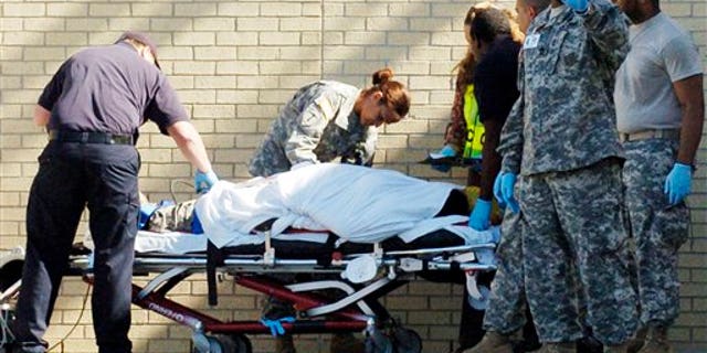 Nov. 5: Emergency personnel transport an unidentified soldier from the Soldier Readiness Center following a shooting at Fort Hood, Texas.