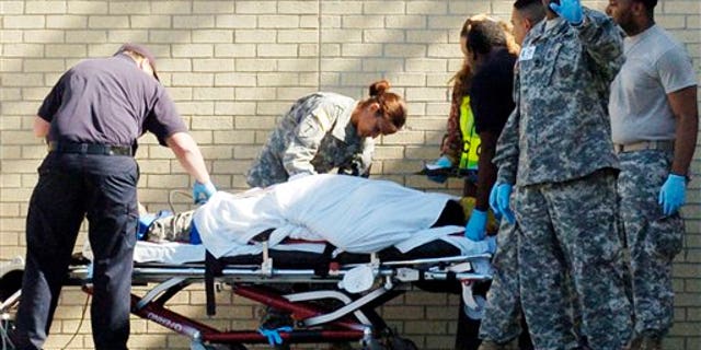 Nov. 5: Emergency personnel transport an unidentified soldier from the Soldier Readiness Center following a shooting at Fort Hood, Texas.