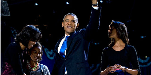 Nov. 7, 2012: President Barack Obama, accompanied by first lady Michelle Obama and daughters Malia and Sasha arrive at the election night party in Chicago.