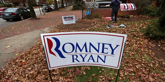 Nov. 7, 2012: A campaign worker removes candidate signs from in front of Mitt Romney's campaign office in Manchester, N.H.