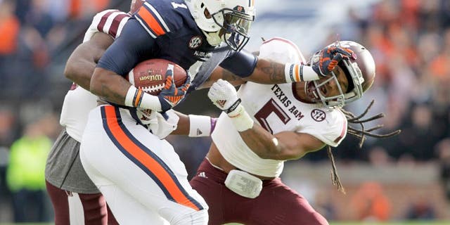 Nov 8, 2014; Auburn, AL, USA; Auburn Tigers receiver receiver D'haquille Williams (1) blocks Texas A&M Aggies defensive back Floyd Raven, Sr. (5) during the first half at Jordan Hare Stadium. Mandatory Credit: John Reed-USA TODAY Sports