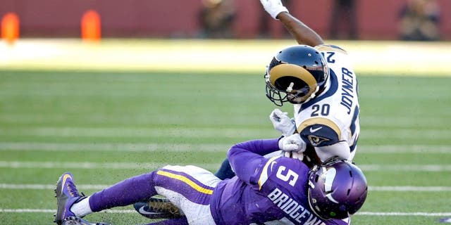 Nov 8, 2015; Minneapolis, MN, USA; St. Louis Rams cornerback Lamarcus Joyner (20) collides with Minnesota Vikings quarterback Teddy Bridgewater (5) for a personal foul in the fourth quarter at TCF Bank Stadium. Bridgewater did not return. The Vikings win 21-18. Mandatory Credit: Bruce Kluckhohn-USA TODAY Sports