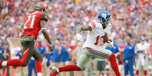 Nov 8, 2015; Tampa, FL, USA; New York Giants wide receiver Odell Beckham (13) runs with the ball as Tampa Bay Buccaneers cornerback Alterraun Verner (21) defends during the first quarter at Raymond James Stadium. Mandatory Credit: Kim Klement-USA TODAY Sports