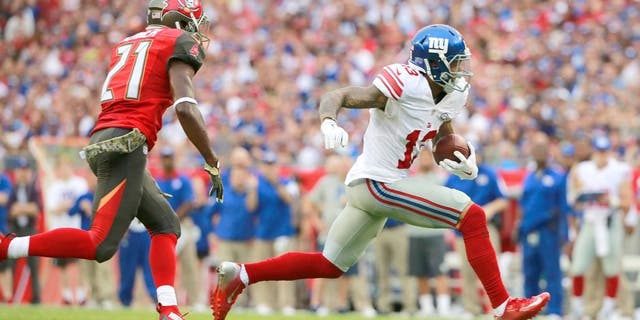 Nov 8, 2015; Tampa, FL, USA; New York Giants wide receiver Odell Beckham (13) runs with the ball as Tampa Bay Buccaneers cornerback Alterraun Verner (21) defends during the first quarter at Raymond James Stadium. Mandatory Credit: Kim Klement-USA TODAY Sports