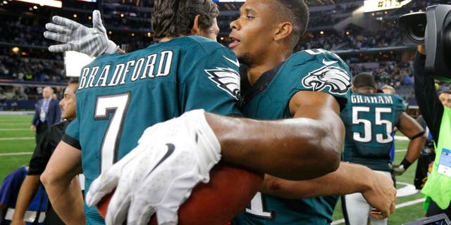 Philadelphia Eagles' Sam Bradford (7) and Jordan Matthews (81) celebrate a touchdown catch made by Matthews in overtime of an NFL football game against the Dallas Cowboys on Sunday, Nov. 8, 2015, in Arlington, Texas. The Eagles won 33-27. (AP Photo/Brandon Wade)
