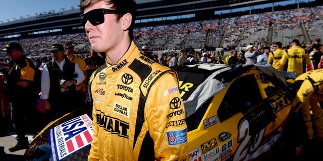 FORT WORTH, TX - NOVEMBER 08: Erik Jones, driver of the #20 DeWalt Toyota, stands on the grid during the NASCAR Sprint Cup Series AAA Texas 500 at Texas Motor Speedway on November 8, 2015 in Fort Worth, Texas. (Photo by Rainier Ehrhardt/NASCAR via Getty Images)